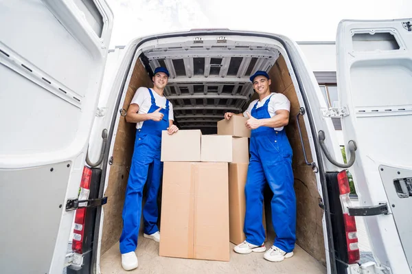 depositphotos_507288494-stock-photo-two-removal-company-workers-unloading